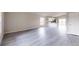 Bright and airy living room with grey vinyl flooring and open kitchen at 5348 Se 91St Pl, Ocala, FL 34480