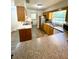 Galley kitchen with wood cabinets and stainless steel appliances overlooking laundry area at 2710 Sw 36Th Dr, Ocala, FL 34474