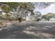 Community basketball court with two hoops, shaded by large trees at 4348 Sw Deepwater Ct, Dunnellon, Fl, FL 34431