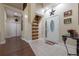 Inviting entryway with wood floors, a unique staircase, and a glass-paneled door at 4348 Sw Deepwater Ct, Dunnellon, Fl, FL 34431