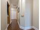 Hallway with hardwood floors, neutral paint, and access to multiple rooms at 4348 Sw Deepwater Ct, Dunnellon, Fl, FL 34431