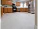 Traditional kitchen featuring wood cabinets, black appliances, stainless steel refrigerator, and light countertops at 4348 Sw Deepwater Ct, Dunnellon, Fl, FL 34431