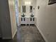 Modern bathroom featuring dual vanities, a glass vessel sink, and updated fixtures, creating a spa-like atmosphere at 611 Water Rd # 103H, Ocala, FL 34472