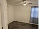 Bedroom with dark tile flooring, a ceiling fan, natural light from the window, and a calm, inviting atmosphere at 611 Water Rd # 103H, Ocala, FL 34472