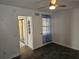 Bedroom featuring a sliding glass door to the backyard, a window, and consistent tile flooring at 611 Water Rd # 103H, Ocala, FL 34472