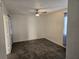 Bright bedroom with dark tile flooring, a ceiling fan, and soft natural light filtering through the curtains at 611 Water Rd # 103H, Ocala, FL 34472