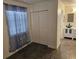 Bedroom featuring a double-door closet, dark tile flooring, and a glimpse into the en suite bathroom at 611 Water Rd # 103H, Ocala, FL 34472