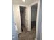 Hallway with access to a bathroom with a shower and a bedroom, featuring consistent tile flooring at 611 Water Rd # 103H, Ocala, FL 34472