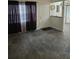 Inviting living room with dark tile flooring, natural light from the window, and sleek, modern finishes at 611 Water Rd # 103H, Ocala, FL 34472