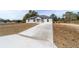 New home with gray siding and a long concrete driveway at 14293 Sw 32Nd Pl, Ocala, FL 34481