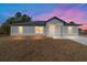 Newly constructed home with gray siding and a covered porch at 14293 Sw 32Nd Pl, Ocala, FL 34481