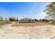 Rear view of a single story house with gray siding and large yard at 14293 Sw 32Nd Pl, Ocala, FL 34481