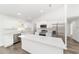 Modern white kitchen with stainless steel appliances and an island at 14293 Sw 32Nd Pl, Ocala, FL 34481