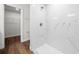 Walk-in shower with white marble tile, silver fixtures, and a glass door at 14409 Sw 30Th Pl, Ocala, FL 34481