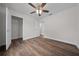 Bedroom featuring wood-look floors, ceiling fan, closet, and white trim at 14409 Sw 30Th Pl, Ocala, FL 34481