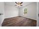 Bedroom with hardwood flooring, ceiling fan, and large window at 14409 Sw 30Th Pl, Ocala, FL 34481