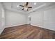 Large bedroom showcasing a ceiling fan, tray ceiling and wood-look floors at 14409 Sw 30Th Pl, Ocala, FL 34481