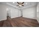 This bedroom has a ceiling fan, wood-look floors, and a neutral color palette at 14409 Sw 30Th Pl, Ocala, FL 34481