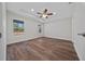 Spacious bedroom featuring wood-look flooring, ceiling fan, and bright windows at 14409 Sw 30Th Pl, Ocala, FL 34481