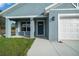 Close up of a blue house featuring a covered porch with a well-manicured lawn and white trim at 14409 Sw 30Th Pl, Ocala, FL 34481