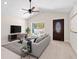 Bright living room featuring modern furniture, a vaulted ceiling with ceiling fan, and a window at 14409 Sw 30Th Pl, Ocala, FL 34481