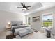 Well-lit main bedroom includes a ceiling fan, bedside tables, and a large bed at 14409 Sw 30Th Pl, Ocala, FL 34481