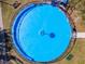 A bird's eye view of a bright blue splash pad with benches and safety fence in a well maintained community park at 14550 Sw 61St Ct, Ocala, FL 34473