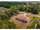 Aerial view of home with covered lanai, long driveway, and well-maintained lawn at 14550 Sw 61St Ct, Ocala, FL 34473