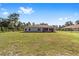 Large backyard showcasing a covered patio with ample space for seating and outdoor activities at 14550 Sw 61St Ct, Ocala, FL 34473