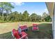 Large green backyard with cozy patio furniture, perfect for relaxing or entertaining at 14550 Sw 61St Ct, Ocala, FL 34473