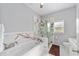 Bright bathroom featuring a soaking tub, a glass shower with modern tile and fixtures at 14550 Sw 61St Ct, Ocala, FL 34473