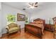 Comfortable bedroom featuring wood floors, bright windows, and classic wood furniture at 14550 Sw 61St Ct, Ocala, FL 34473