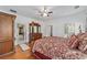 Spacious bedroom with classic wooden furniture, hardwood floors, and ample natural light at 14550 Sw 61St Ct, Ocala, FL 34473