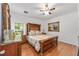 Warm bedroom with a large bed, elegant furniture and hardwood floors at 14550 Sw 61St Ct, Ocala, FL 34473