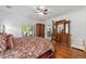 Bright bedroom with a view to the exterior, classic wooden furniture, and hardwood floors at 14550 Sw 61St Ct, Ocala, FL 34473