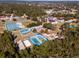 Aerial view of community featuring tennis, basketball, and shuffleboard courts, a splashpad and clubhouse at 14550 Sw 61St Ct, Ocala, FL 34473