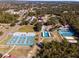 Aerial view of community featuring tennis, basketball, and shuffleboard courts, a splashpad and clubhouse at 14550 Sw 61St Ct, Ocala, FL 34473