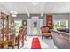 Inviting foyer with a grand dining table, complemented by elegant furniture and bright natural light at 14550 Sw 61St Ct, Ocala, FL 34473