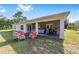 Covered patio featuring exercise equipment and a BBQ grill overlooking the lush backyard at 14550 Sw 61St Ct, Ocala, FL 34473