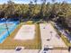 Aerial view of community recreation area featuring a basketball court, a beach volleyball court and a tennis court at 14550 Sw 61St Ct, Ocala, FL 34473