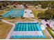 Aerial view of the community recreation area featuring basketball, shuffleboard, and tennis courts at 14550 Sw 61St Ct, Ocala, FL 34473