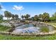 Picturesque water feature with rocks, small waterfalls, and lush landscaping at 14550 Sw 61St Ct, Ocala, FL 34473