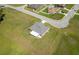 Expansive aerial view of a home with a covered patio and a well-manicured lawn in a residential community at 25 Nw 45Th Loop, Ocala, FL 34475