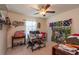 Charming bedroom featuring a ceiling fan, window, and craft and sewing supplies at 25 Nw 45Th Loop, Ocala, FL 34475