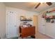 Bedroom featuring neutral walls, ceiling fan, two doors and shelves along the walls at 25 Nw 45Th Loop, Ocala, FL 34475