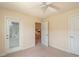 Bright bedroom featuring plush carpeting, and access to additional rooms at 25 Nw 45Th Loop, Ocala, FL 34475