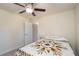 Comfortable bedroom featuring patterned quilt, and a ceiling fan, promoting relaxation at 25 Nw 45Th Loop, Ocala, FL 34475