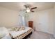 Bedroom with patterned quilt, ceiling fan, and natural light, providing a cozy atmosphere at 25 Nw 45Th Loop, Ocala, FL 34475