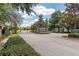 Elegant community entrance with stone pillars, wrought iron gates, and manicured landscaping at 25 Nw 45Th Loop, Ocala, FL 34475