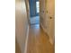 Light-filled hallway with wood-look floors and access to other rooms at 25 Nw 45Th Loop, Ocala, FL 34475